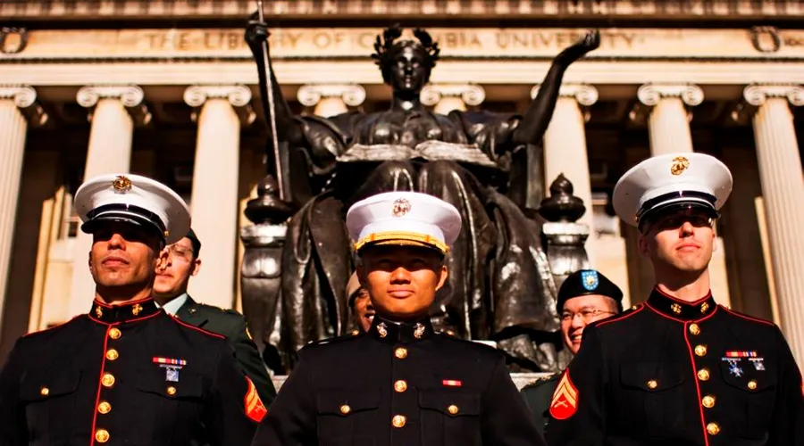 Newly-commissioned officers pose for a photo in front of Alma Mater and Low Library