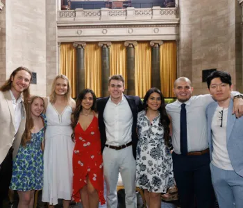 A group of eight smiling Postbac Premed students