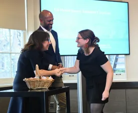 Student receiving their Honor Society certificate from Dean Rosen-Metsch.