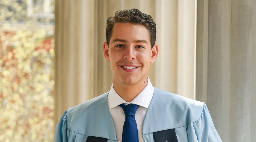 Christian Rodgriguez poses in graduation robe