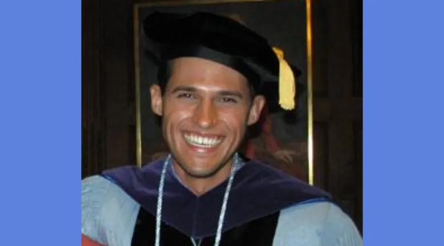 GS alumnus Christopher Riano '07 smiles in his cap and gown.