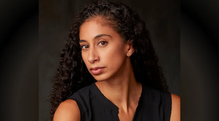 Alicia Graf Mack '03GS in front of a dark background