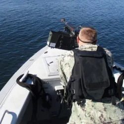 David Garland '26GS on a harbor patrol boat during his time in the U.S. Navy.
