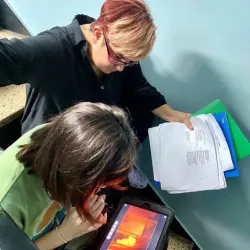 Valerie Pires '24GS with a crew member reviewing footage on the set of Left, Unsaid