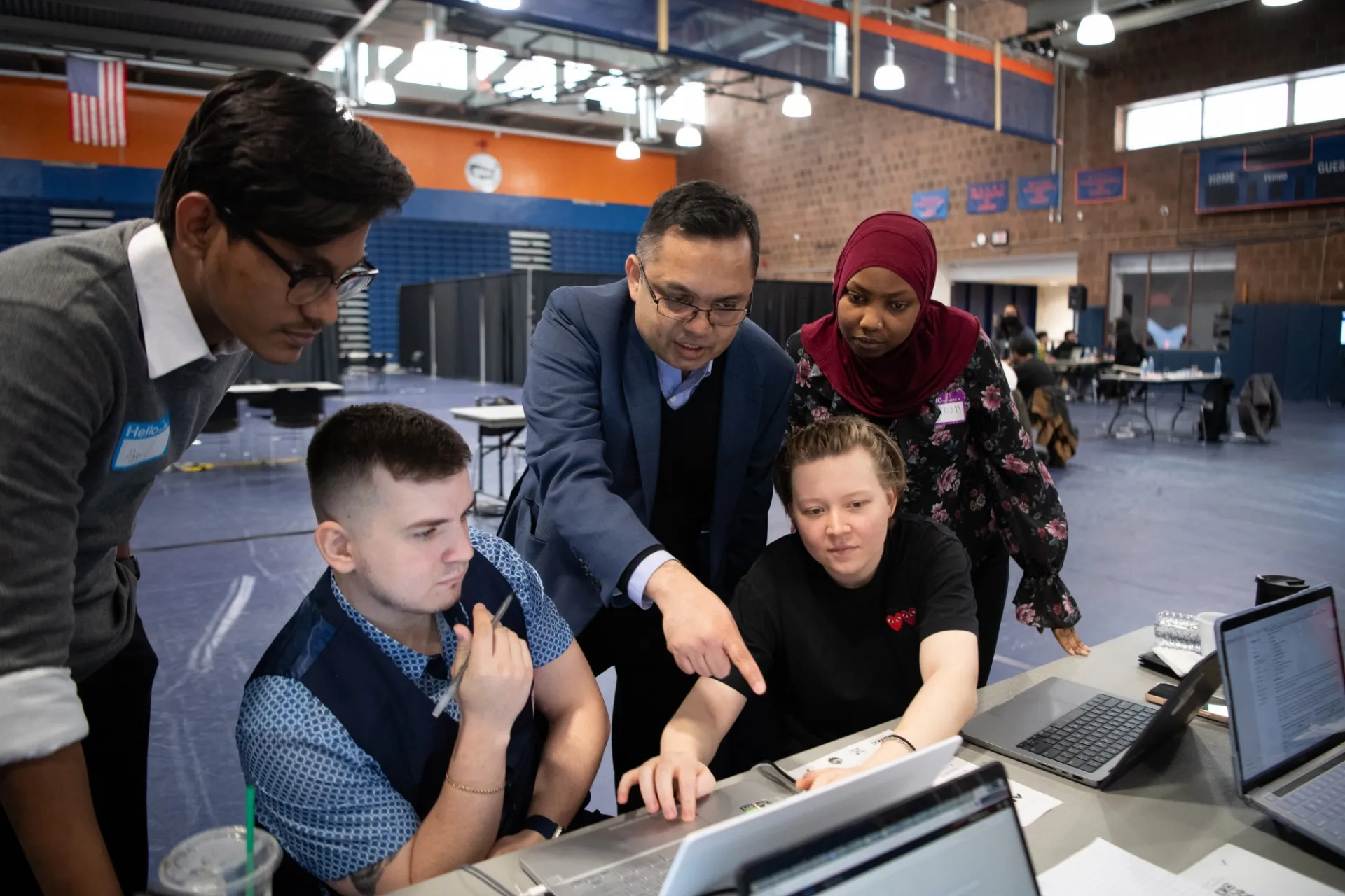 BMCC students over a computer
