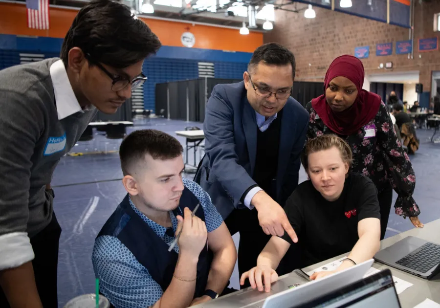 A group of BMCC students around a computer