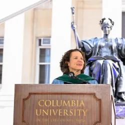 President Armstrong standing at podium