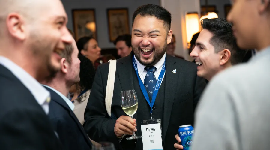 Attendees mingling at a 2025 GS Reunion event at Le Monde