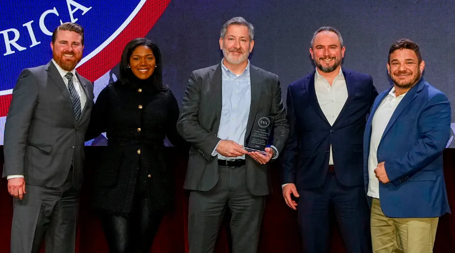 A group of representatives from Columbia University Center for Veteran Transition and Integration recieve an award from Student Veterans of America CEO Jared Lyon