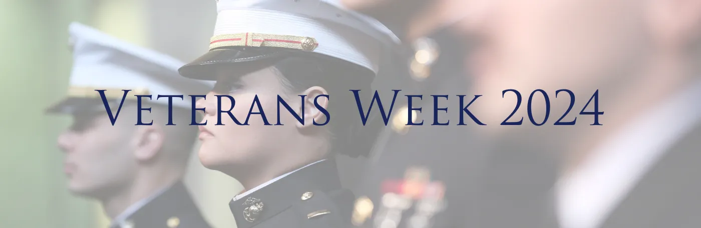 Several military veterans in uniform stand in a line with Veterans Week 2024 written in text across the center