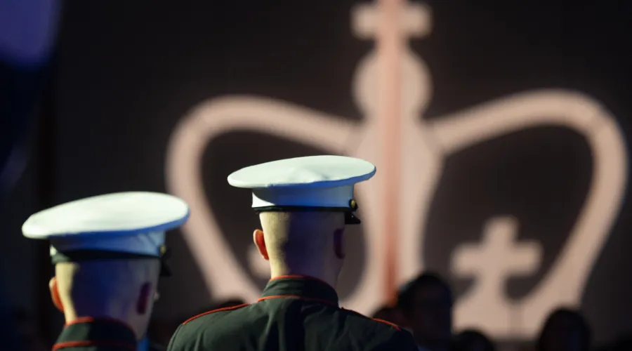 Silhouettes of two military veterans against the backdrop of the Columbia logo 